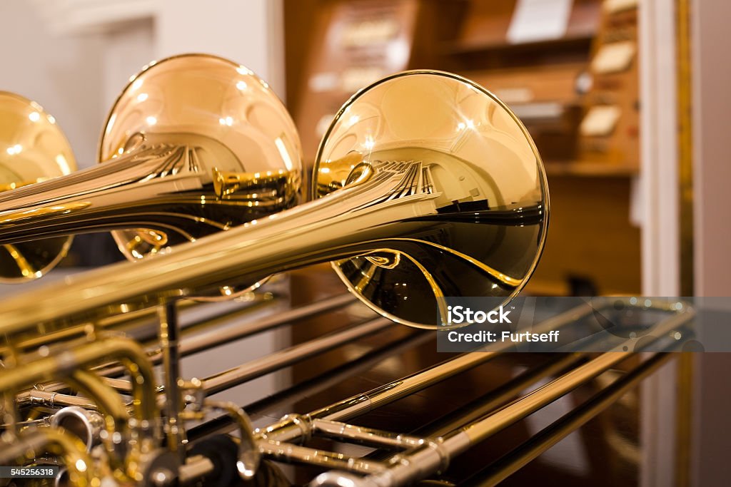 Fragment trombones closeup Fragment trombones closeup on the table Trombone Stock Photo