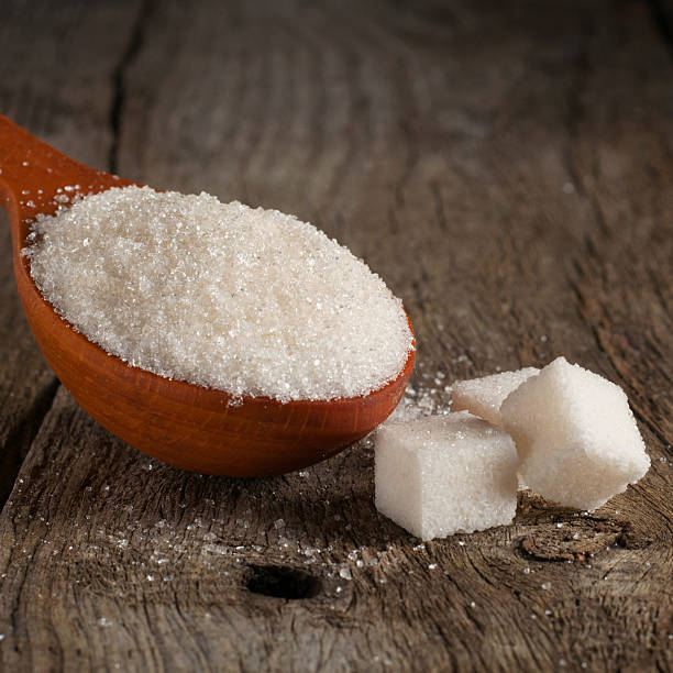 istock white sugar in wood spoon with sugar cubes closeup 545256860
