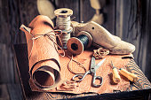 Cobbler workshop with leather, threads and tools
