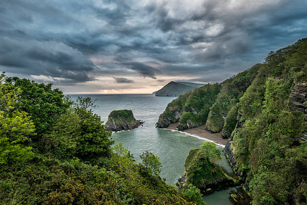 istock Beautiful dramatic sunrise landsape image of small secluded cove 545257572