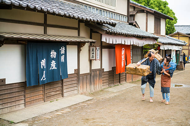 istock Man and boy bearing load like in old times, Japan 545261306
