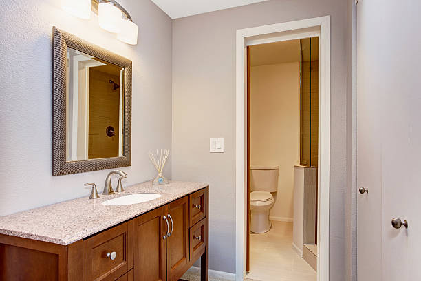 istock Modern bathroom with vanity cabinet, granite counter top and mirror. 545266698