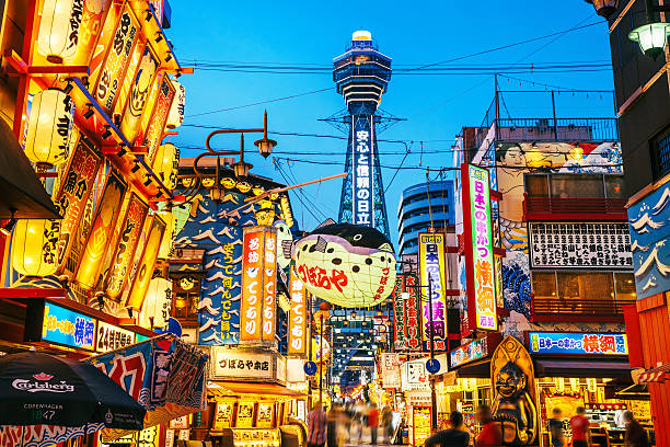 Osaka Tower and view of the neon advertisements Shinsekai district stock photo