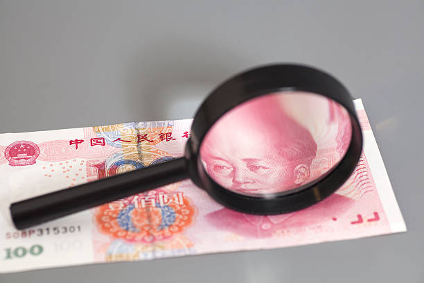 istock Yuan chinese money with magnifier glass 545267458
