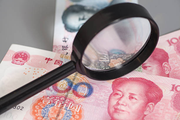 istock Yuan chinese money with magnifier glass 545267918