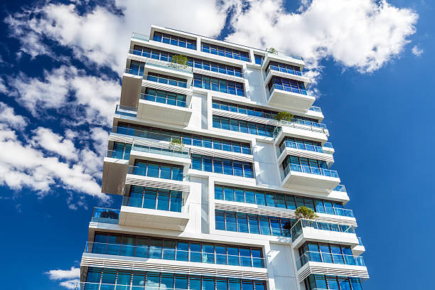 istock Apartment House with blue sky and clouds 545267924