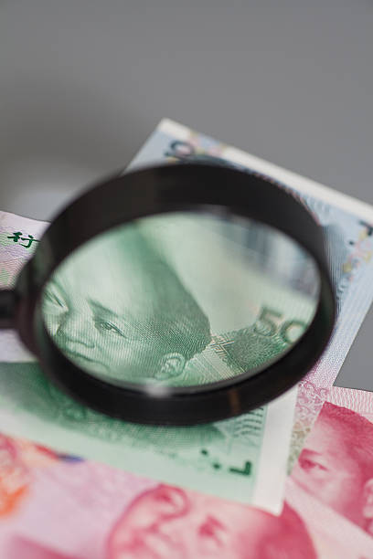 istock Yuan chinese money with magnifier glass 545268372