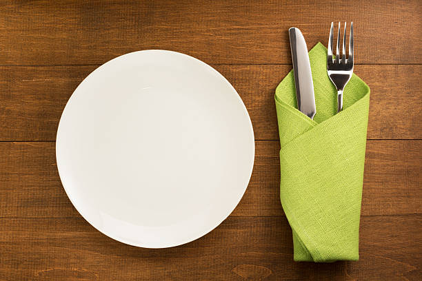 istock knife and fork with napkin on wood 545268506