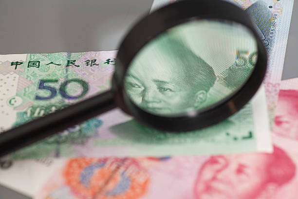 istock Yuan chinese money with magnifier glass 545268530