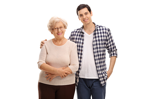 Cheerful young man posing together with his grandmother isolated on white background
