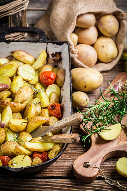 istock Baked potatoes with rosemary, garlic and cherry tomatoes 545269494