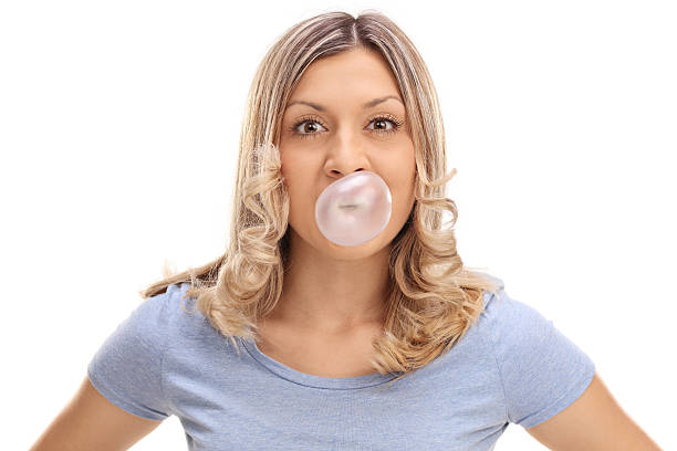 istock Woman blowing a bubble from a gum 545269834