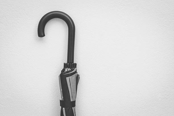 istock The  umbrella on the wall background - black and white 545270156