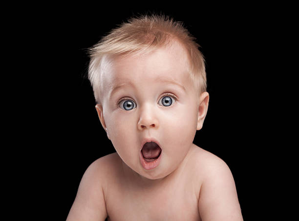 newborn baby portrait with funny shocked face expression
