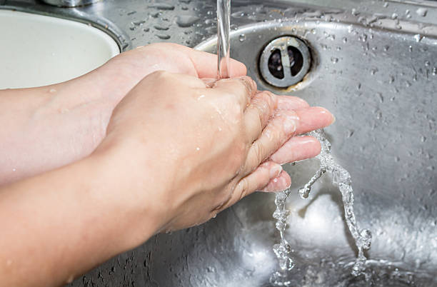 istock Woman washing hand under running 545271758