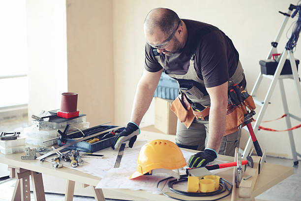 istock Male carpenter in working clothes in a construction workshop 545272900
