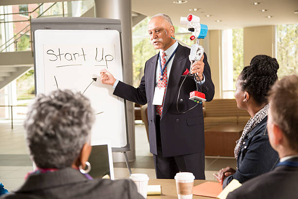 istock New business start-up. Man demonstrates invention, robot prototype. 545274768