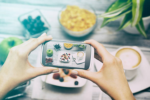 taking photo of food with smart phone. - blueberry fruit berry berry fruit imagens e fotografias de stock