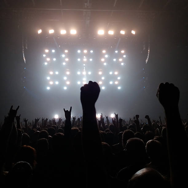 Audience with hands raised at a rock concert stock photo