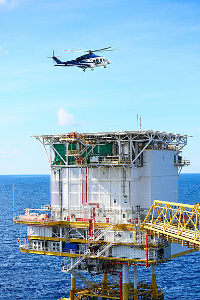 istock helicopter parking landing on offshore platform, Helicopter transfer crews 545276982