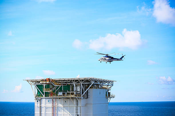 istock helicopter parking landing on offshore platform, Helicopter transfer crews 545277382