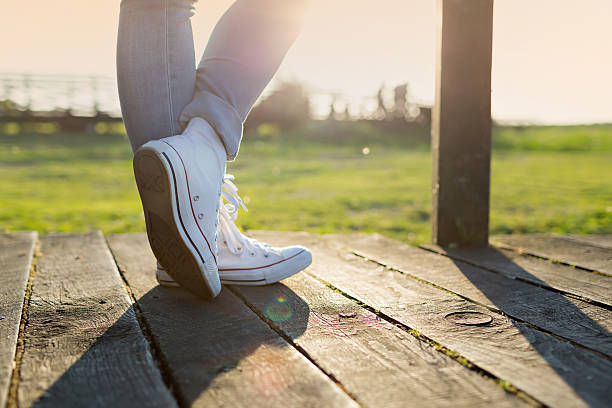 istock woman legs in trainers 545278426