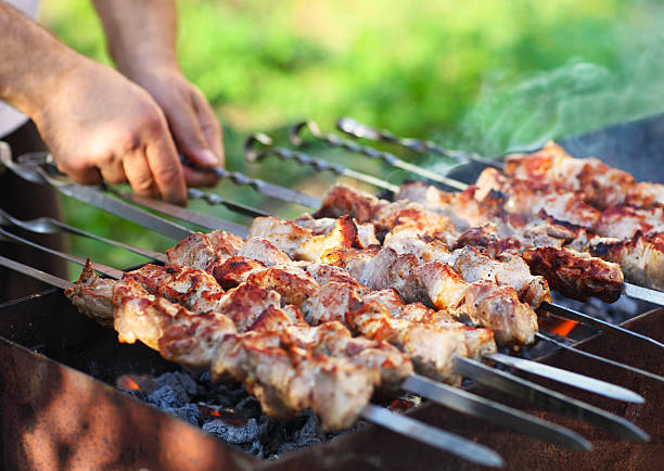 istock Marinated shashlik, lamb meat grilling on metal skewer, close up 545279742