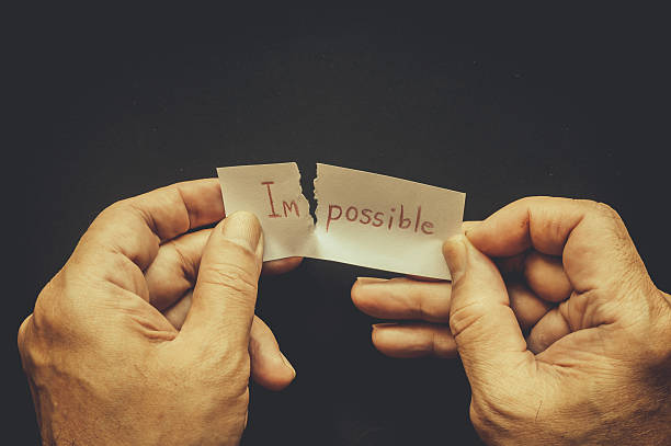 istock Tearing the word impossible on paper to possible 545280428