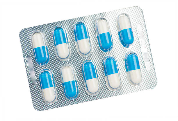 Blue and white capsule in blister pack show medicine concept