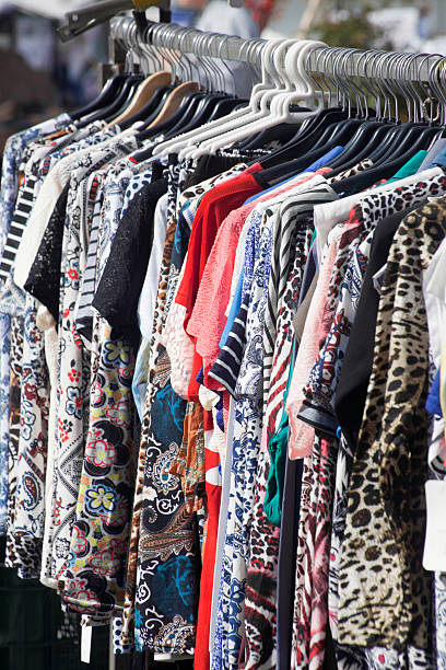istock Multicolored blouses hanging in an outdoor market. 545282526