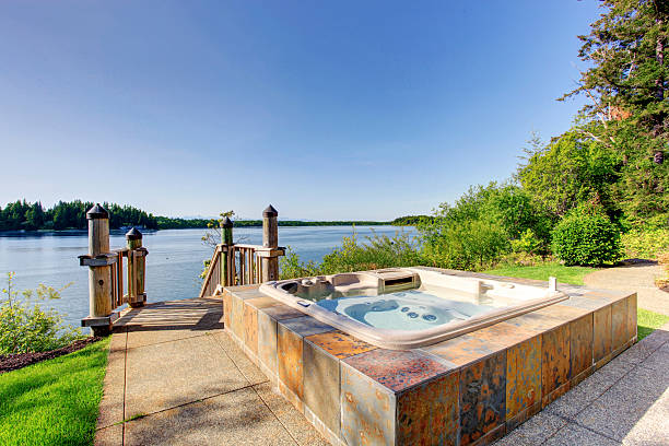 istock Backyard area with hot tub and awesome water view. 545282810