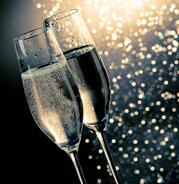 istock champagne flutes with golden bubbles 545284360