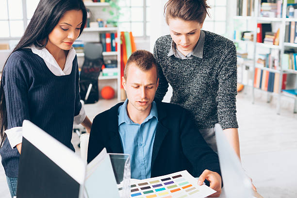 istock Graphic designer and his assistants at workplace 545284910