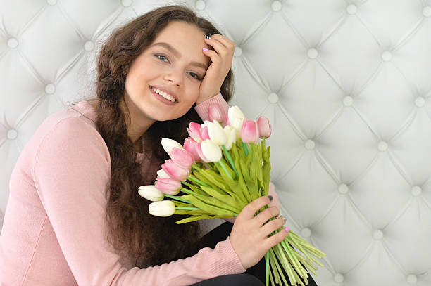istock beautiful  woman  with tulips 545285456