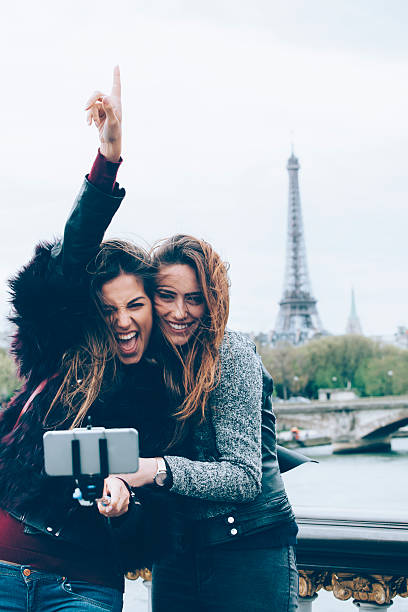 istock Smiling women making selfie with monopod on a bridge 545285460