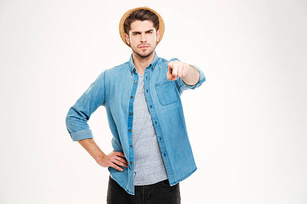 istock Serious attractive young man standing and pointing to camera 545285508