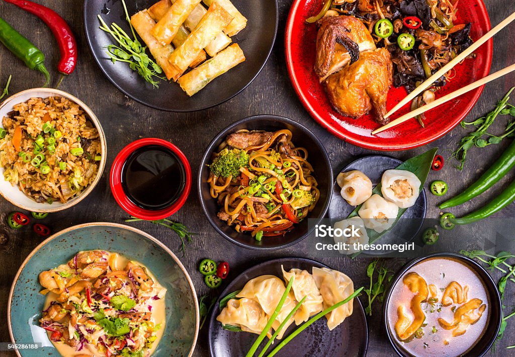 Chinese food blank background Assorted Chinese food set. Chinese noodles, fried rice, dumplings, peking duck, dim sum, spring rolls. Famous Chinese cuisine dishes on table. Top view. Chinese restaurant concept. Asian style banquet Chinese Food Stock Photo