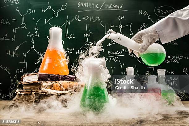 Checking The Chemical Formula In Academic Laboratory Stock Photo - Download Image Now