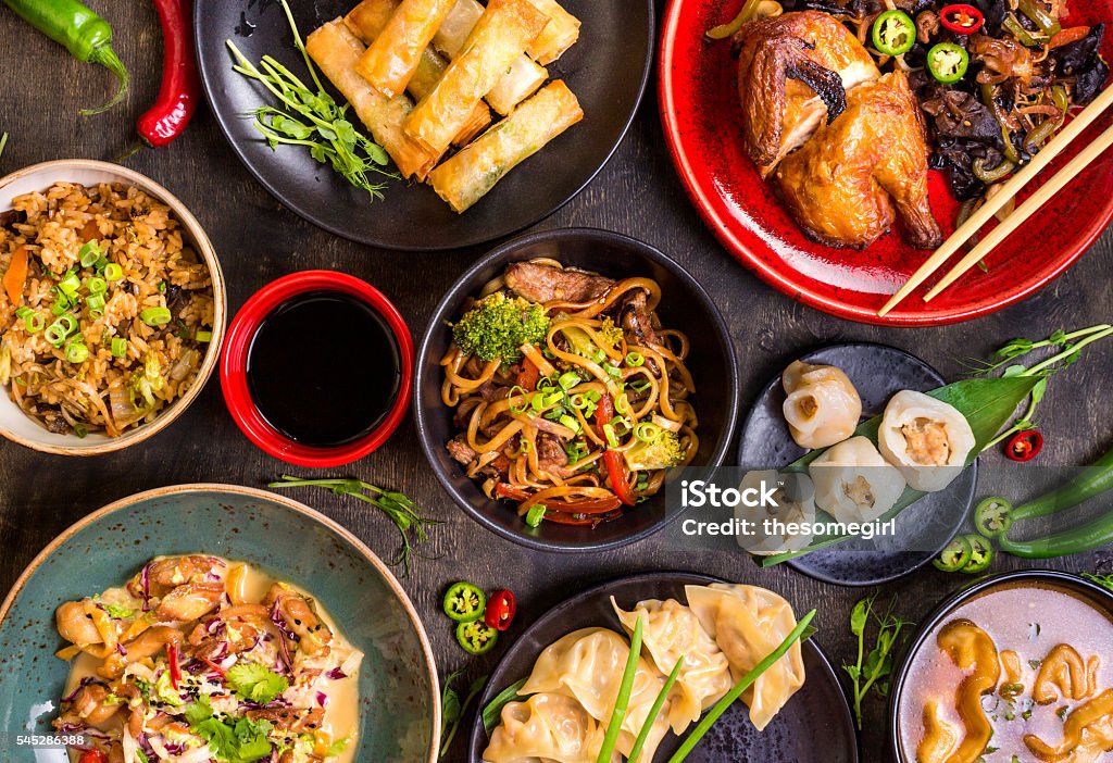 Chinese food blank background Assorted Chinese food set. Chinese noodles, fried rice, dumplings, peking duck, dim sum, spring rolls. Famous Chinese cuisine dishes on table. Top view. Chinese restaurant concept. Asian style banquet Chinese Food Stock Photo