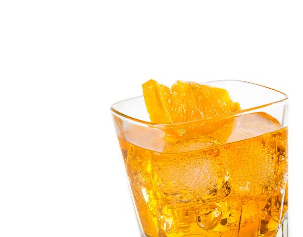 istock yellow cocktail with orange slice isolated on white background 545333742
