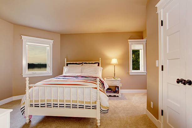 istock Simple beige bedroom interior with carpet floor and two windows. 545333964