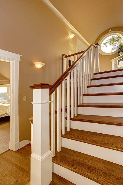 istock House interior. Hallway with wooden staircase and white railings. 545334056