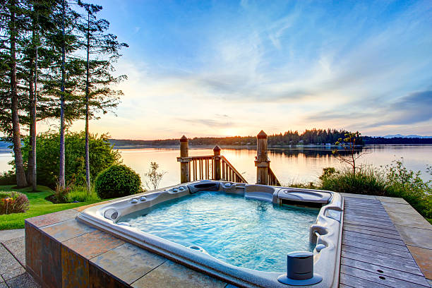 Awesome water view with hot tub in summer evening. Awesome water view with hot tub in summer evening. House exterior. hot tub stock pictures, royalty-free photos & images
