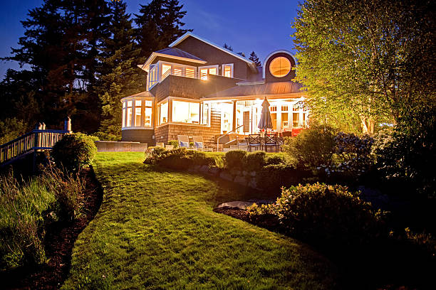 istock Large two story house with lots of lights 545335698