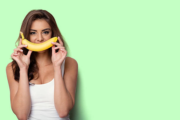 istock woman making fun with a banana. 545337144