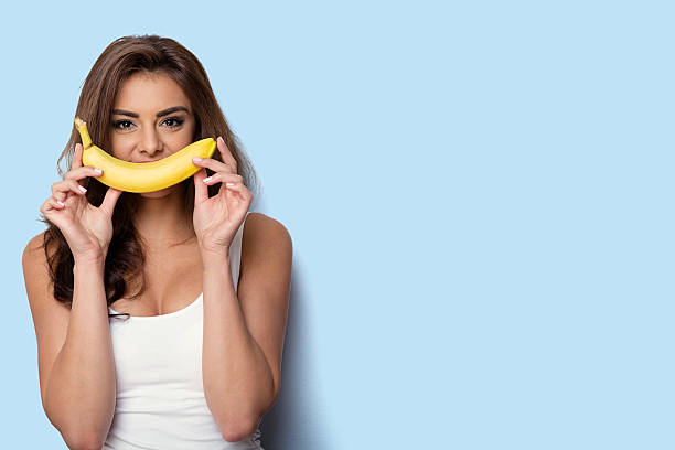istock woman making fun with a banana. 545337854