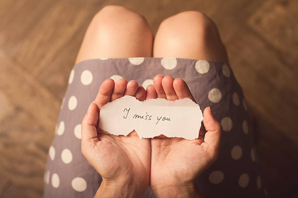 istock Woman holding a paper note text I miss you 545338064