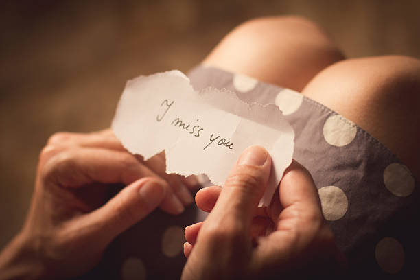istock Woman holding a note with text I miss you 545338428