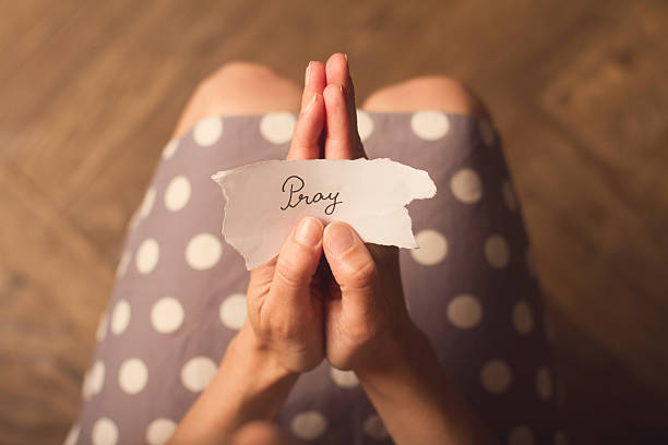 istock Woman holding a note with the text pray 545339126