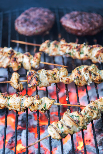 Grilled chicken kebabs with burgers.